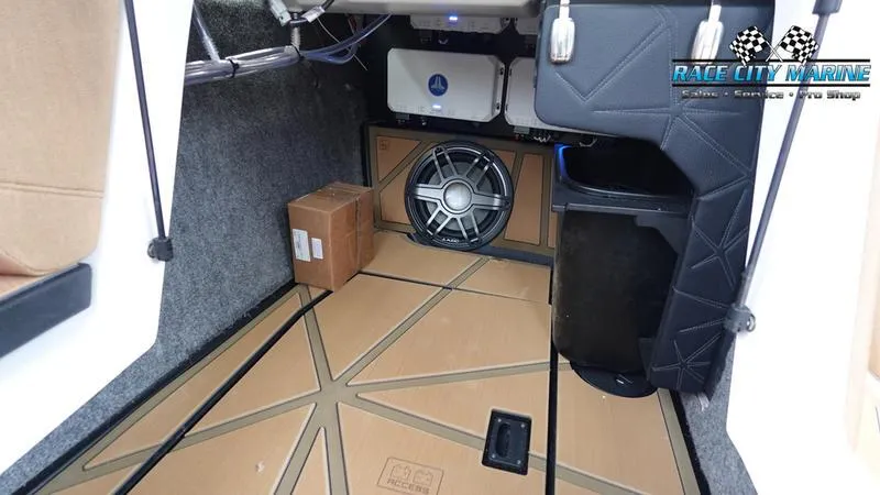 Slide: The Image of 2025 Nautique Super Air Nautique G23 Paragon interior storage with audio system and Race City Marine logo. - 39