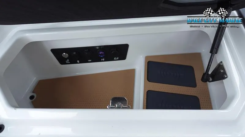 Slide: The Image of 2025 Nautique Super Air Nautique G23 Paragon storage compartment with control panel and cushioned mats. - 40