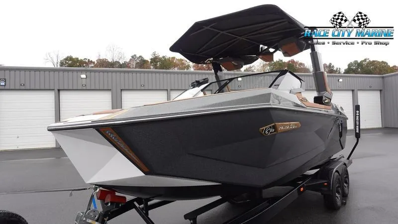 Slide: The Image of 2025 Nautique Super Air Nautique G23 Paragon boat in a marina setting. - 6