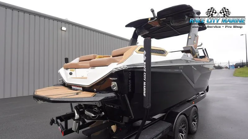 Slide: The Image of 2025 Nautique Super Air Nautique G23 Paragon boat on trailer, Race City Marine logo. - 8