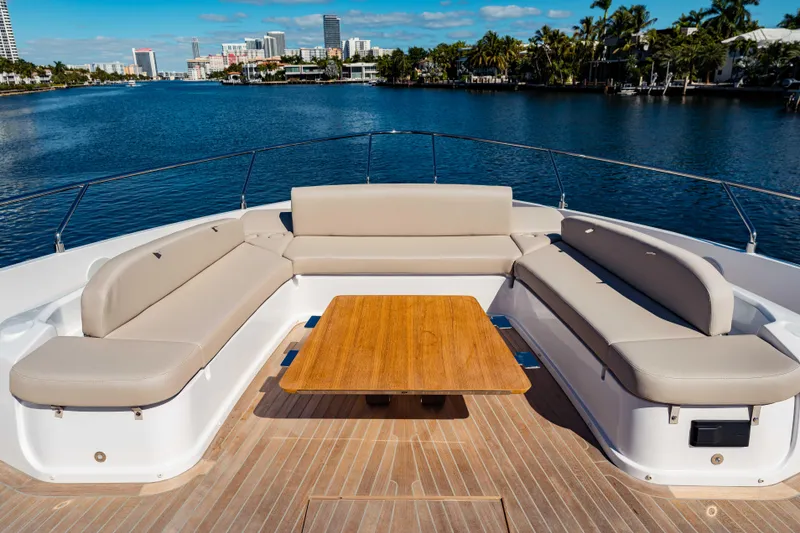 Slide: The Image of Luxurious 2023 Ferretti Yachts 860 with elegant deck seating and scenic waterfront view. - 12