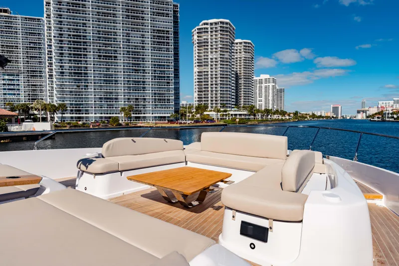 Slide: The Image of Luxurious 2023 Ferretti Yachts 860 with elegant deck seating, city skyline backdrop. - 13