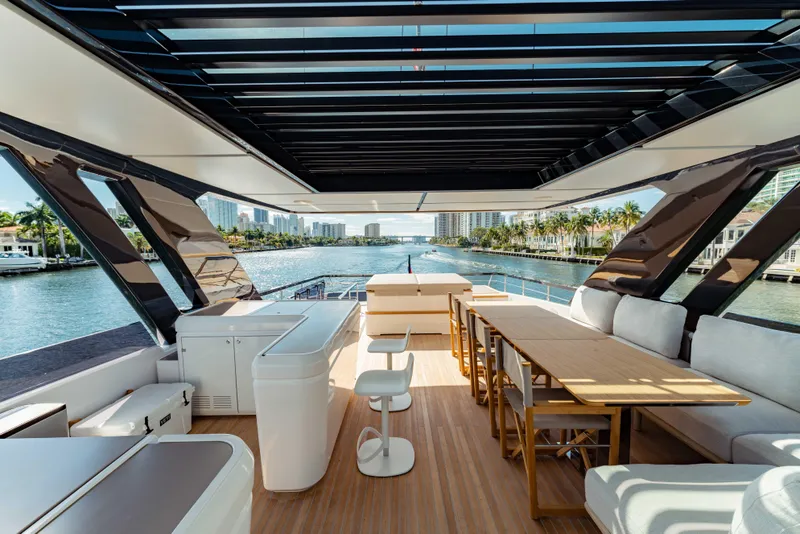 Slide: The Image of Luxurious 2023 Ferretti Yachts 860 interior with modern seating and scenic waterway view. - 21