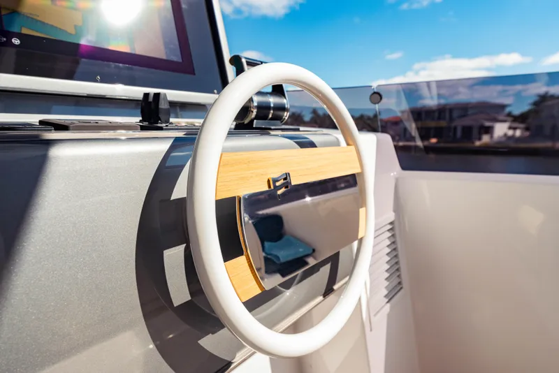 Slide: The Image of Steering wheel of 2023 Ferretti Yachts 860 under clear blue sky. - 23