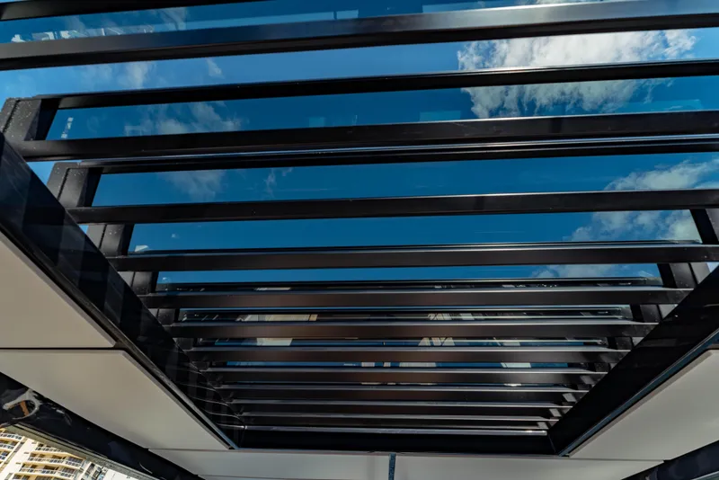 Slide: The Image of Modern glass roof of 2023 Ferretti Yachts 860, showcasing sleek design and blue sky reflection. - 29
