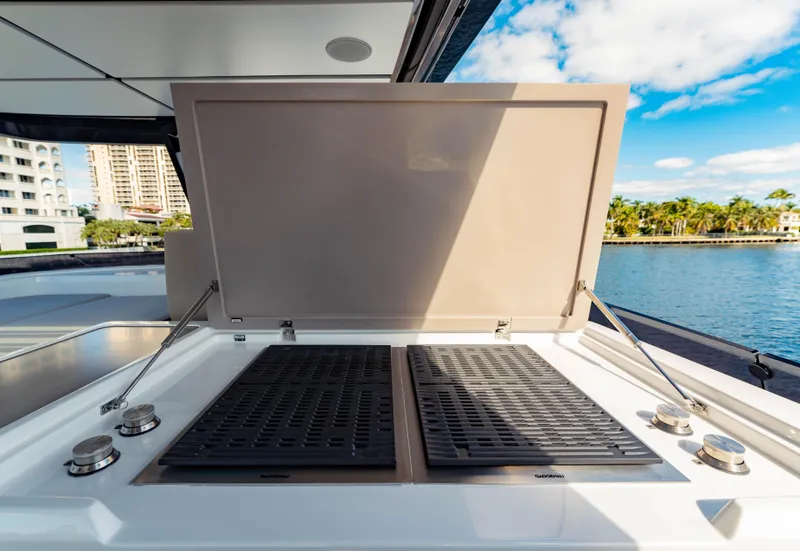 Slide: The Image of Outdoor grill on 2023 Ferretti Yachts 860, docked by waterfront buildings and trees. - 31