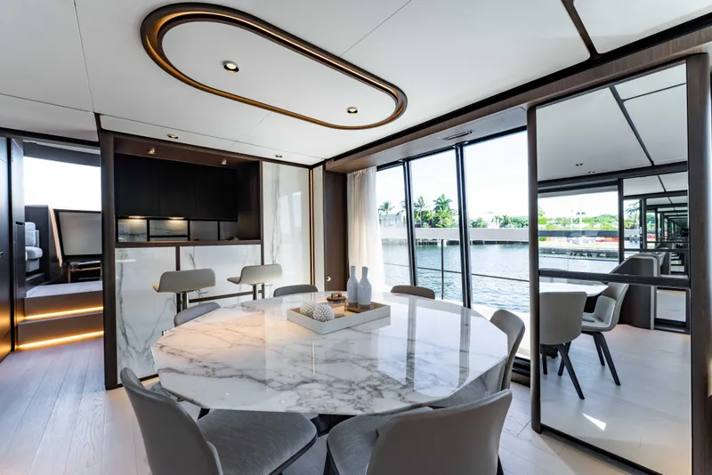 Slide: The Image of Luxurious interior of 2023 Ferretti Yachts 860 with elegant dining area and panoramic windows. - 42