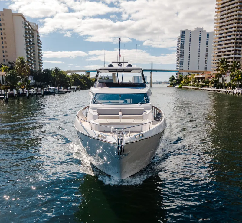 Slide: The Image of 2023 Ferretti Yachts 860 cruising in a sunny urban waterway. - 5