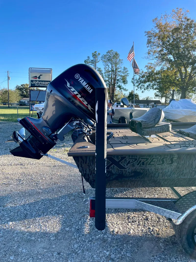 Slide: The Image of 2025 Xpress XP180 boat with Yamaha motor on trailer, outdoors. - 3