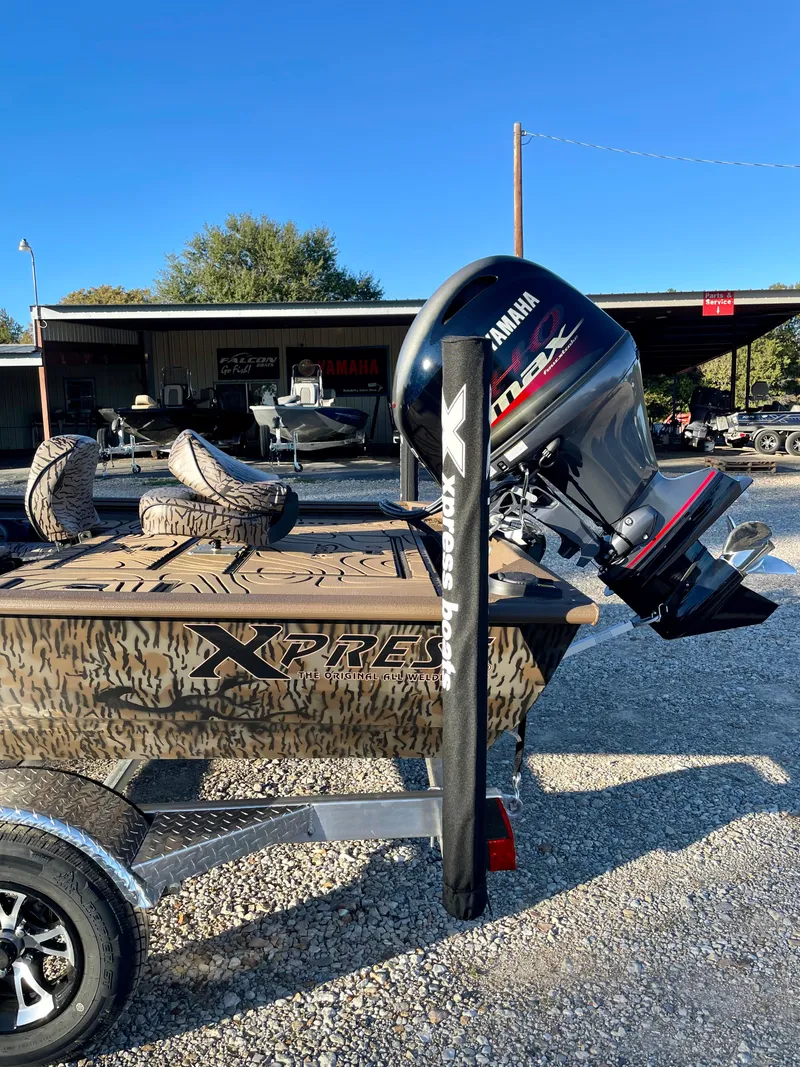 Slide: The Image of 2025 Xpress XP180 boat with Yamaha outboard motor on a trailer. - 6