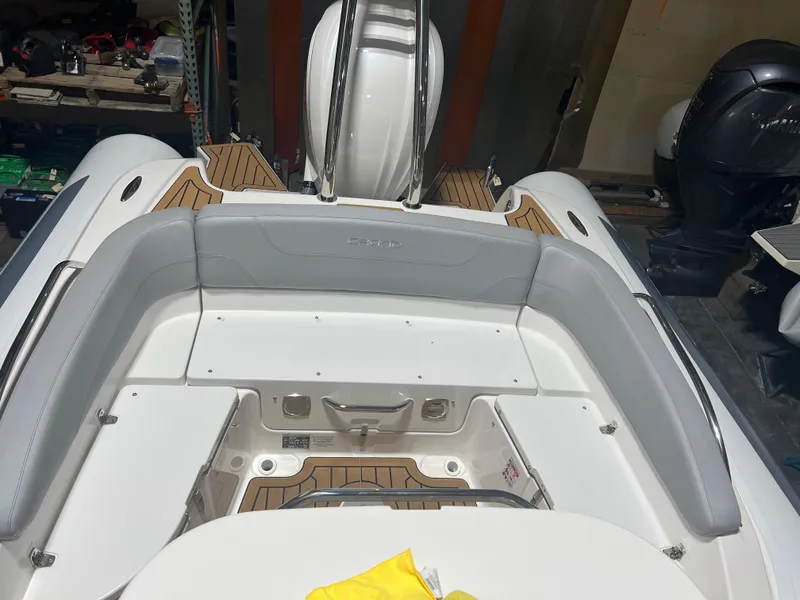 Slide: The Image of 2024 Grand Goldenline 850 boat interior with cushioned seating and teak flooring. - 13