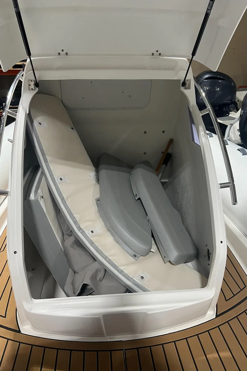 Slide: The Image of 2024 Grand Goldenline 850 boat storage compartment with cushions and accessories. - 15