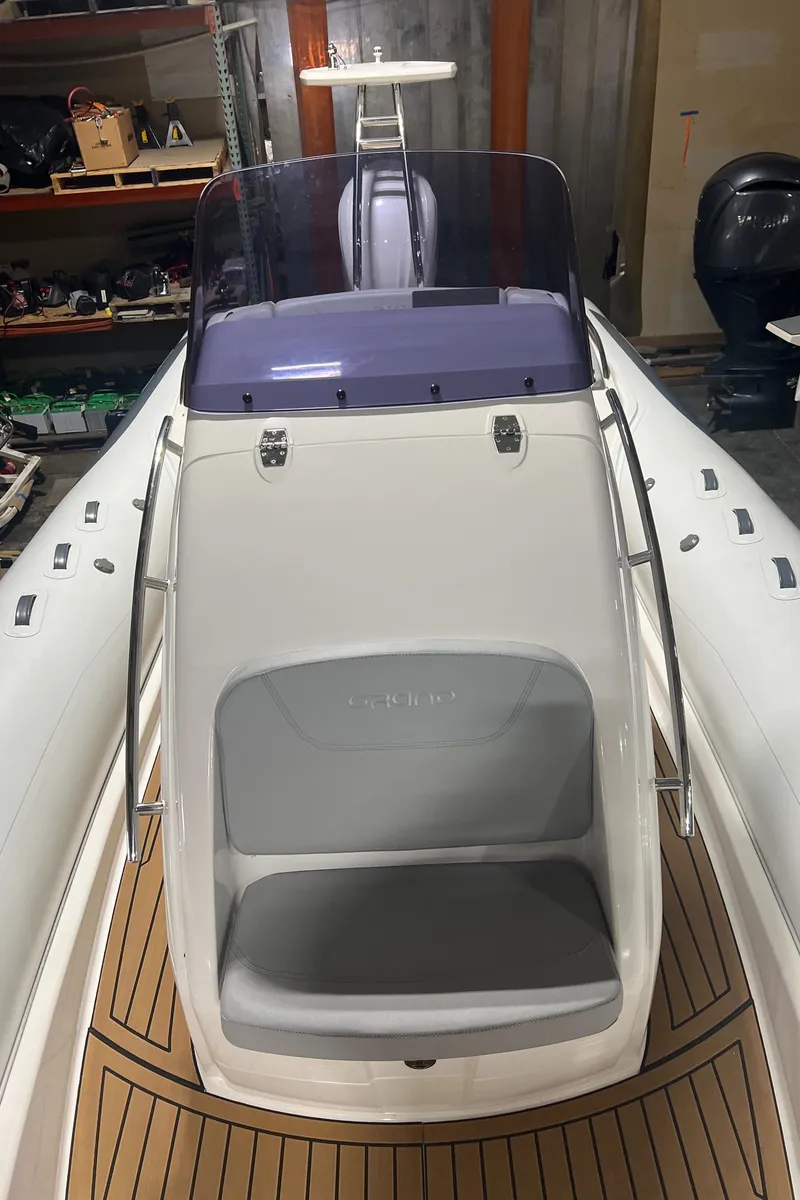 Slide: The Image of 2024 Grand Goldenline 850 boat with sleek design and wooden deck accents. - 16