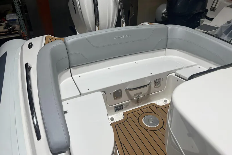 Slide: The Image of 2024 Grand Goldenline 850 boat interior with gray seating and teak flooring. - 17