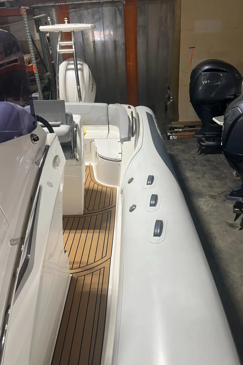 Slide: The Image of 2024 Grand Goldenline 850 boat with sleek design and wooden deck. - 18