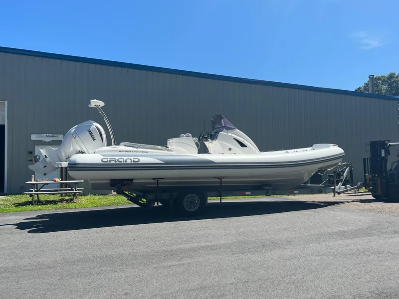 Slide: The Image of 2024 Grand Goldenline 850 boat on trailer outside warehouse. - 4