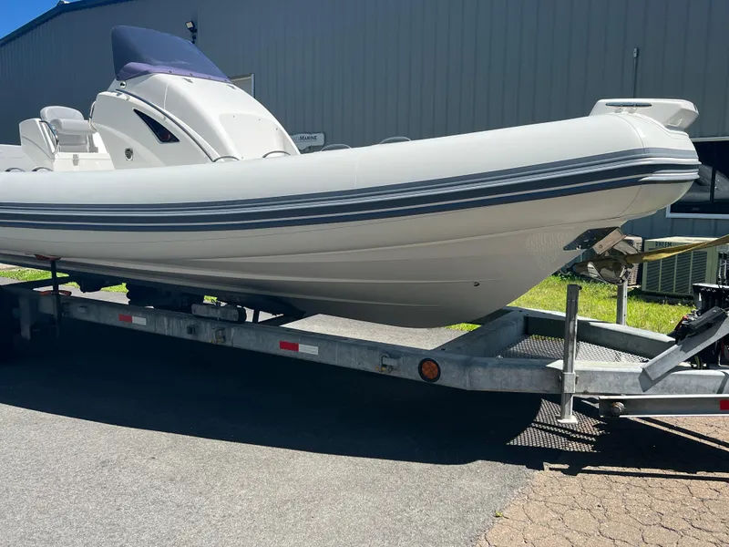 Slide: The Image of 2024 Grand Goldenline 850 boat on trailer, parked outdoors. - 6