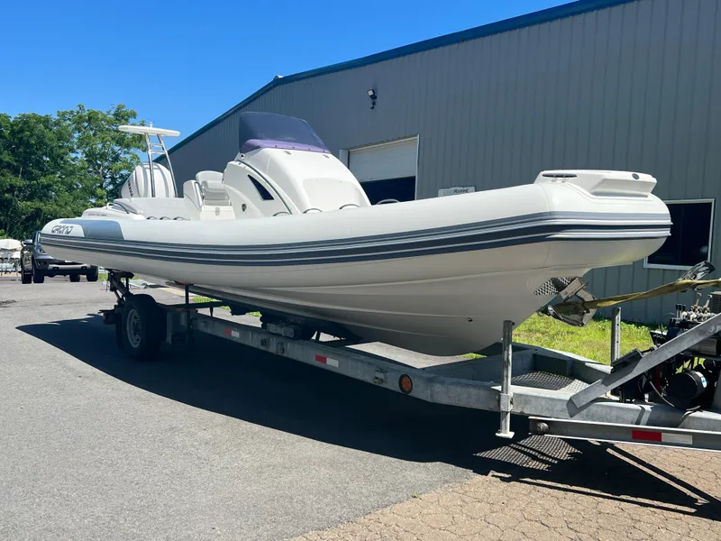 Slide: The Image of 2024 Grand Goldenline 850 boat on trailer, parked outside a warehouse. - 7
