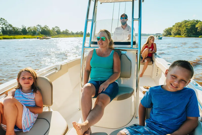 Slide: The Image of Family enjoying a sunny day on a 2025 Key West 203 FS boat. - 6