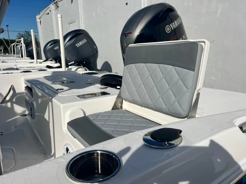 Slide: The Image of 2025 NauticStar 191 Hybrid boat interior with Yamaha engines and cushioned seating. - 11