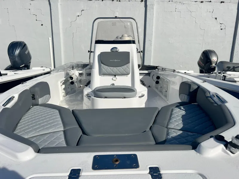Slide: The Image of 2025 NauticStar 191 Hybrid boat interior with gray seating and dual engines. - 4