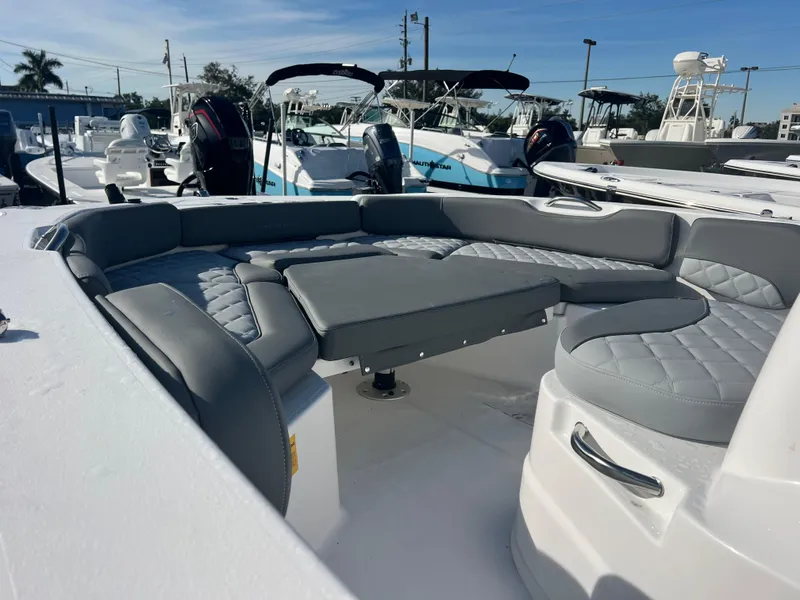 Slide: The Image of 2025 NauticStar 191 Hybrid boat with gray seating in a marina. - 6