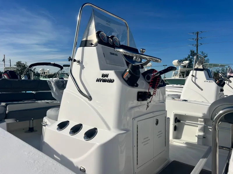 Slide: The Image of 2025 NauticStar 191 Hybrid boat console with steering wheel and controls. - 7