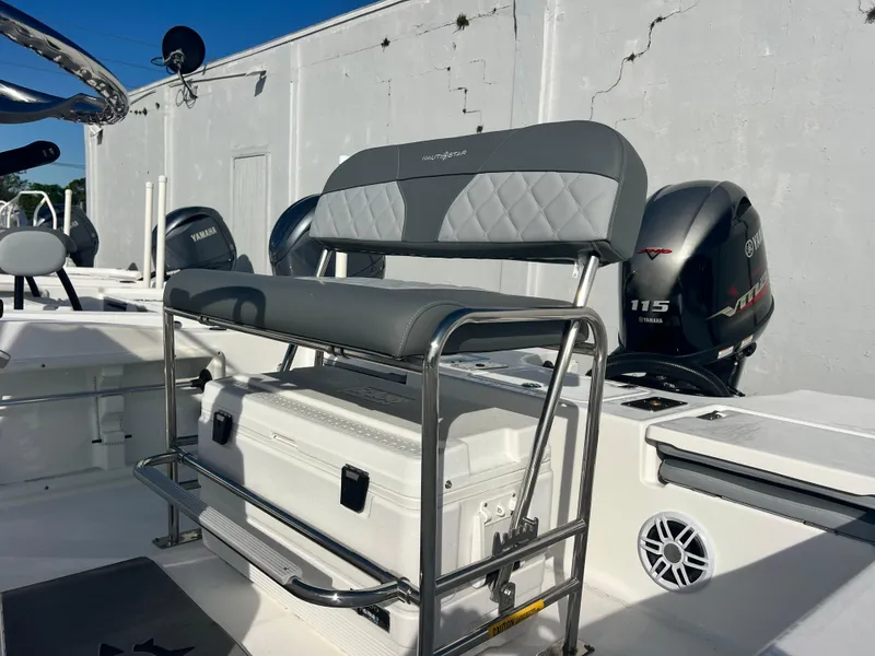 Slide: The Image of 2025 NauticStar 191 Hybrid boat interior with seating and Yamaha outboard engines. - 9
