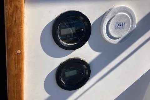 Slide: The Image of Control panel on a 1989 Catalina 30 sailboat with gauges and DMI logo. - 17