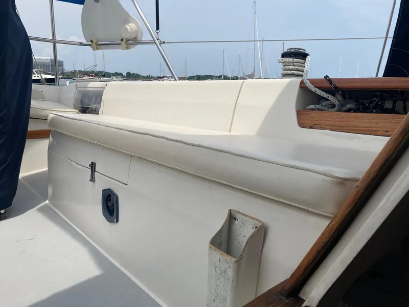 Slide: The Image of 1989 Catalina 30 sailboat cockpit with seating and rigging, docked in a marina. - 26