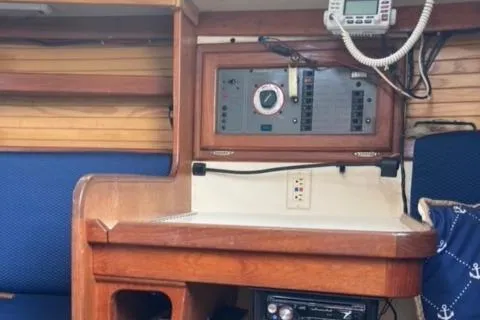 Slide: The Image of Navigation station inside a 1989 Catalina 30 sailboat with control panel and radio. - 35