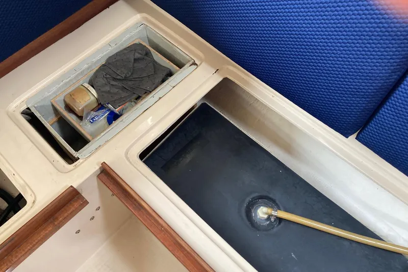 Slide: The Image of Interior view of a 1989 Catalina 30 sailboat showing storage compartments. - 37