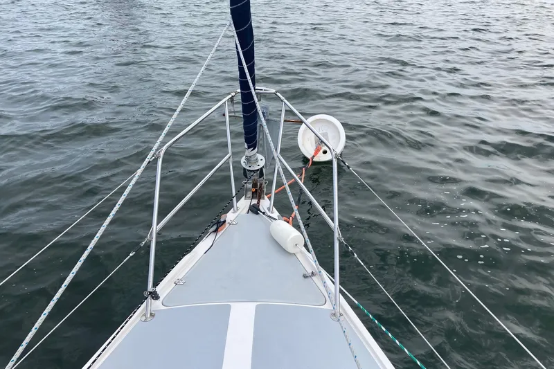 Slide: The Image of Bow of 1989 Catalina 30 sailboat on water, featuring rigging and deck details. - 42