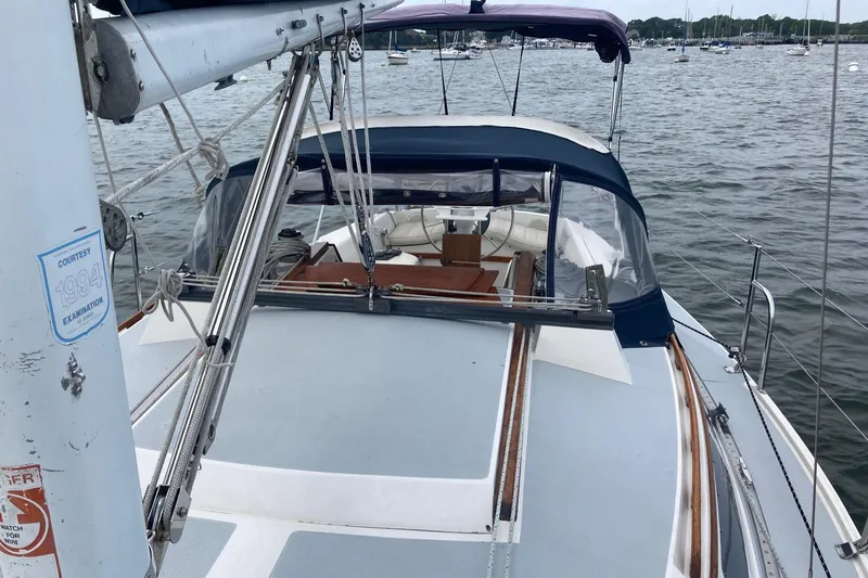 Slide: The Image of 1989 Catalina 30 sailboat on water, featuring deck and cockpit view. - 48