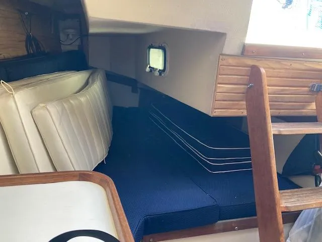 Slide: The Image of Interior cabin of a 1989 Catalina 30 sailboat with cushions and wooden ladder. - 6