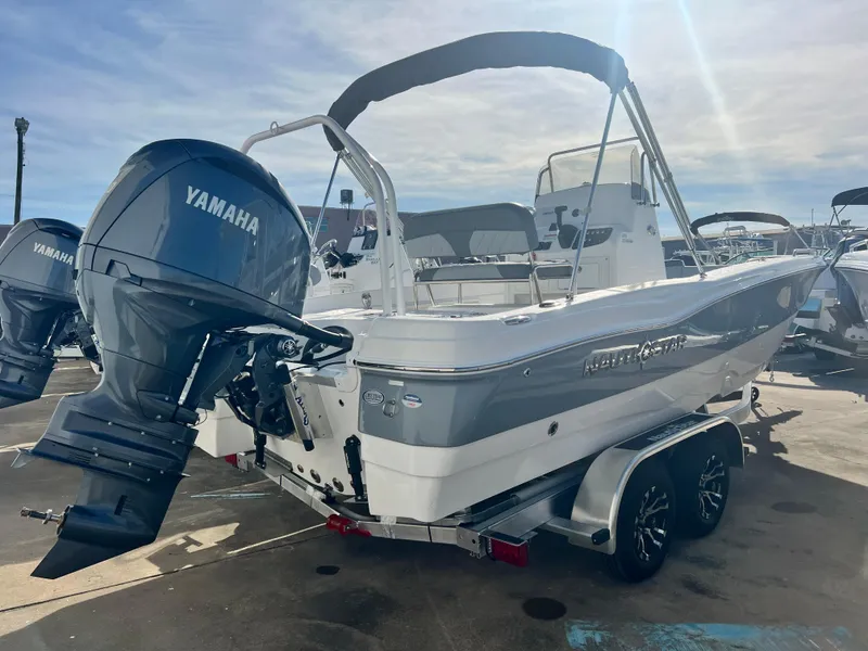 Slide: The Image of 2025 NauticStar 211 Hybrid boat with Yamaha engine on trailer. - 12