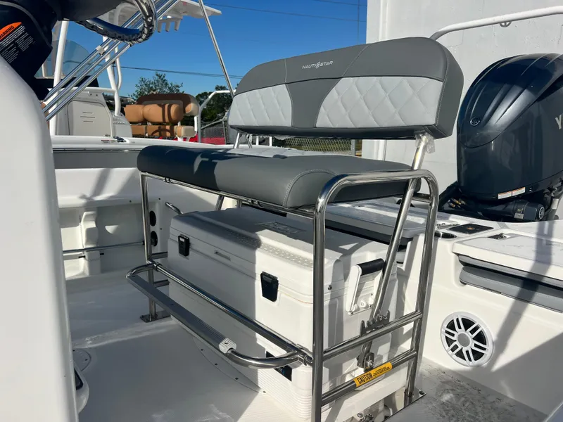 Slide: The Image of 2025 NauticStar 211 Hybrid boat interior with seating and storage. - 3
