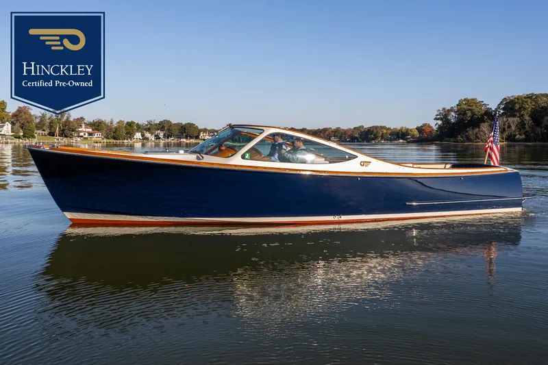 The Image of 2003 Hinckley Talaria 29 Runabout on calm water, certified pre-owned. - 0