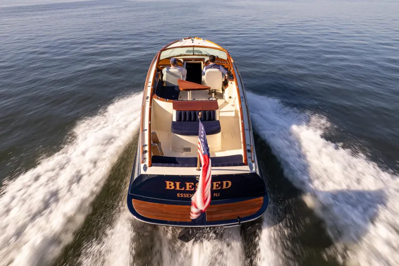 Slide: The Image of 2003 Hinckley Talaria 29 Runabout cruising on open water, rear view. - 14