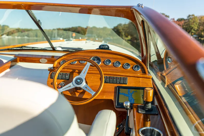 Slide: The Image of 2003 Hinckley Talaria 29 Runabout cockpit with wooden dashboard and steering wheel. - 17
