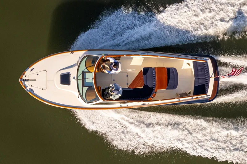 Slide: The Image of 2003 Hinckley Talaria 29 Runabout cruising on water, aerial view. - 2