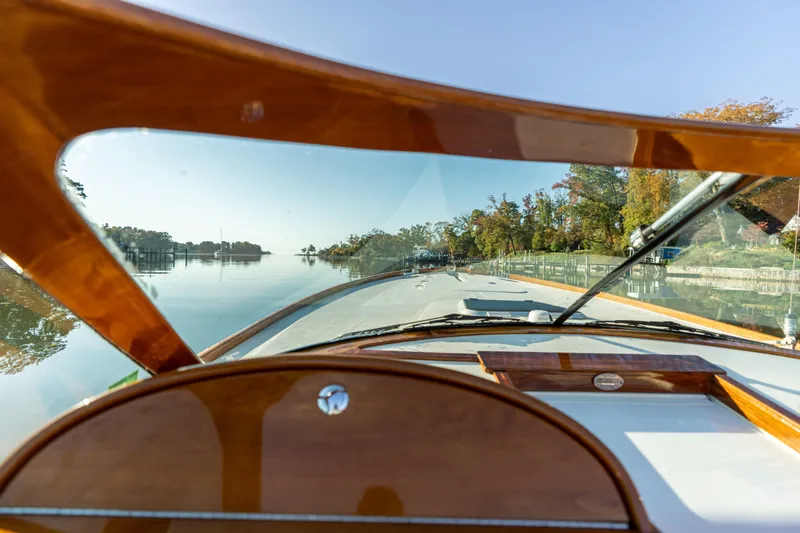 Slide: The Image of Interior view of 2003 Hinckley Talaria 29 Runabout on a calm lake. - 23