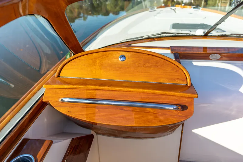 Slide: The Image of 2003 Hinckley Talaria 29 Runabout, elegant wooden dashboard detail, luxury boat interior. - 24