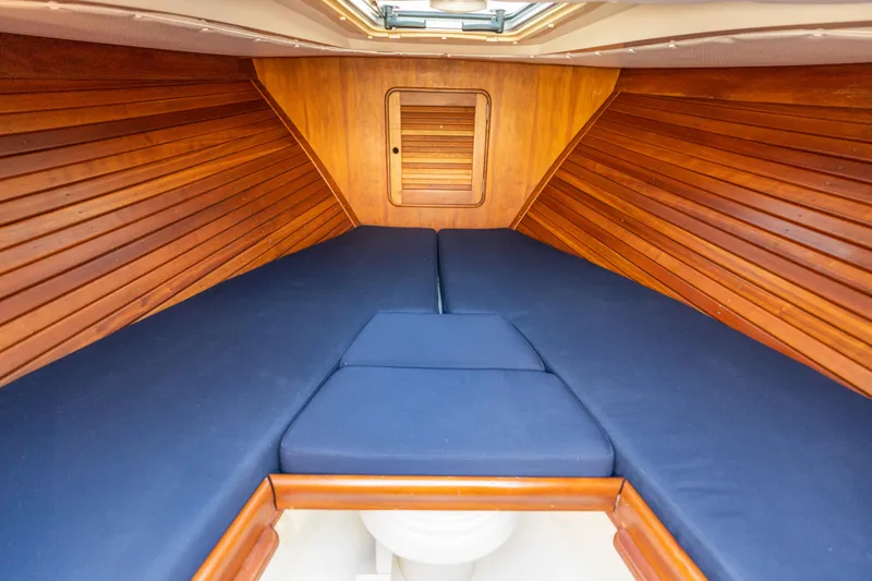 Slide: The Image of Interior cabin of 2003 Hinckley Talaria 29 Runabout with blue cushions and wooden paneling. - 35