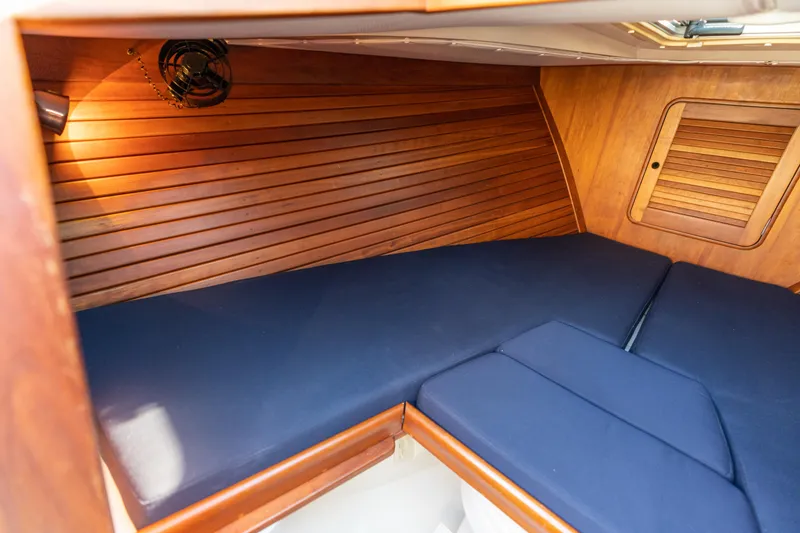 Slide: The Image of Interior cabin of 2003 Hinckley Talaria 29 Runabout with wooden paneling and blue cushions. - 36