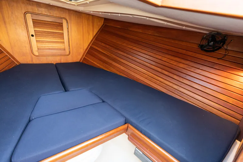 Slide: The Image of 2003 Hinckley Talaria 29 Runabout cabin with blue cushions and wooden interior. - 37