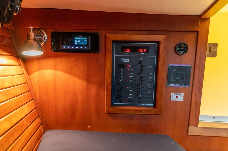 Slide: The Image of Interior of 2003 Hinckley Talaria 29 Runabout with control panel and wooden finish. - 41