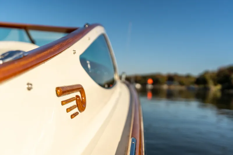 Slide: The Image of 2003 Hinckley Talaria 29 Runabout, elegant design, wooden trim, on calm water. - 45