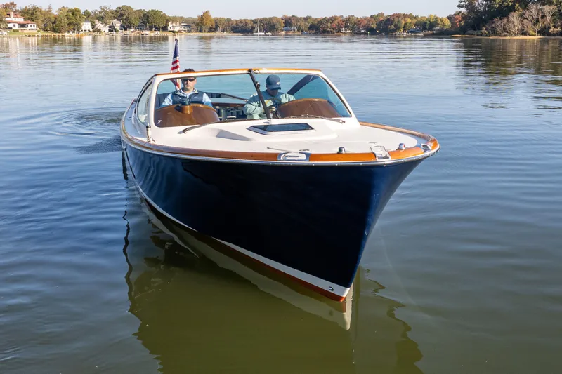 Slide: The Image of 2003 Hinckley Talaria 29 Runabout cruising on a calm lake. - 6