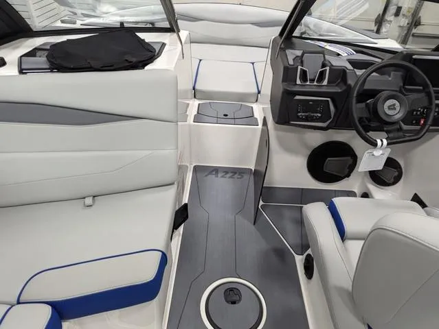Slide: The Image of 2025 Axis A225 boat interior with modern seating and steering console. - 11
